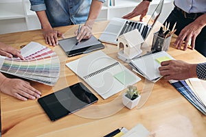 Young colleagues designers working together on a creative project and color samples for selection, Color swatch