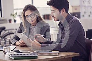 Young colleagues working on the laptop computer