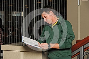 Young College Student reading a book