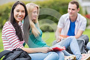 Young college students sitting in the park