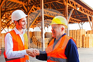 Young company manager thanks to senior foreman