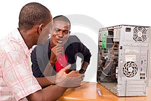 Young computer expert repairing a computer