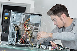 Young computer repairman at work