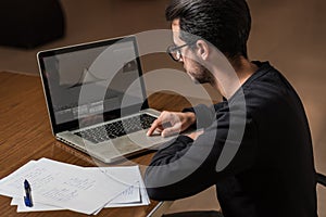 Young computer science student use a laptop to study in Caceres, Spain.