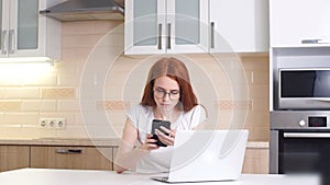 Young concentrated woman, sitting in her room or office.Studies late at night. Working late on laptop.