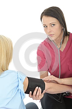 Young Concerned Female Professional Doctor Taking The Blood Pressure Of A Female Patient and Listening with Stethoscope