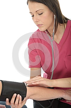 Young Concerned Professional Female Doctor Taking The Blood Pressure Of A Patient and Listening with Stethoscope