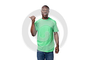 young confident american male advertiser dressed in green t-shirt with mockup gesturing