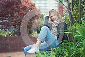 Young confident attractive woman sitting ouside