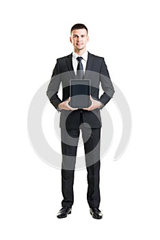 Young and confident business man holding a tablet