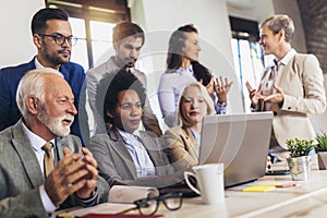 Young confident business people analyzing data using computer while spending time in the office