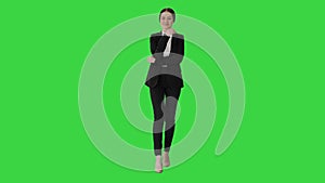 Young confident business woman with folded hands on a Green Screen, Chroma Key.