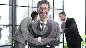 Young Confident Businessman Smiling at the Camera