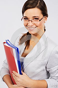 Young confident businesswoman with folders