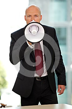 Young confident caucasian businessman screaming at camera