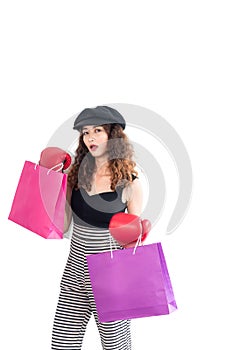 Young confident crazy asian woman wearing red boxing gloves and holding shopping bag isolated on white background. Shopping summer
