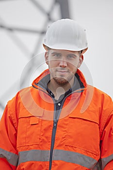 Young confident engineer or architect looking at camera on a construction site