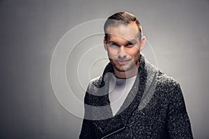 Young confident man looking into the camera.