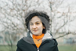 Young confident woman portrait outdoors. Analog film look. Authentic millenial young girl concept photo