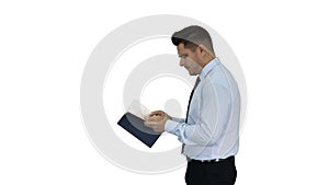 Young confused man trying to read smart book misunderstanding content while walking on white background.