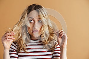 Young confused woman holding her demaged hair photo