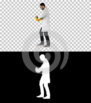 Young construction engineering student walking and putting cap on, Alpha Channel