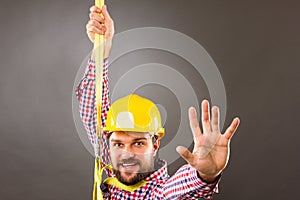 Young construction man withhard hat wearing a fall protection h