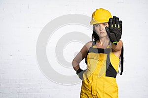 A young construction worker clearly shows that you cannot get close to this place. Occupational Health and Safety