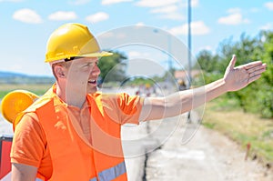 Young construction worker signalling with his hand