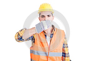 Young constructor covering his mouth with hands