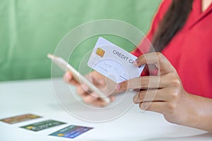 Young consumer woman holding mock up credit card, Ready to spending pay online shopping according to discount products via