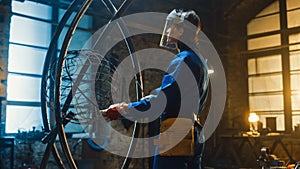 Young Contemporary Female Artist in Blue Jumpsuit and Safety Mask is Fitting a Metal Ring to a Tub