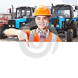 Young contractor shows blue agricultural tractor