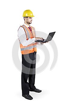 Young contractor working with laptop