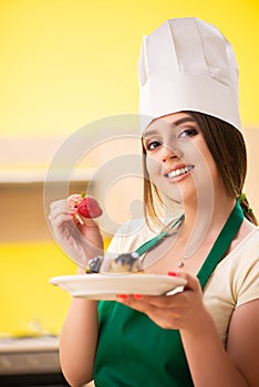 The young cook cooking cakes in the kitchen