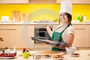 The young cook cooking cakes in the kitchen