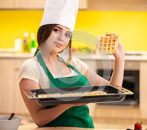 Young cook cooking cakes in the kitchen