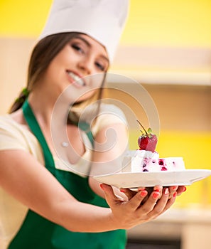 Young cook cooking cakes in the kitchen