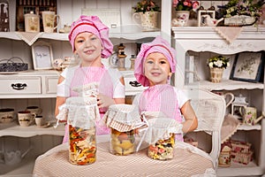 Young cook hostesses with tasty bottled food