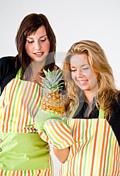 Young cooks with pineapple