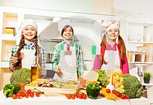 Young cooks preparing traditional Italian meal