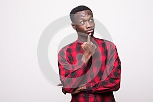 Young cool black man doubting on white background