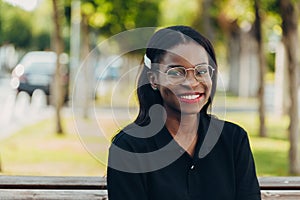 Young cool black skin girl with glasses walking in the street