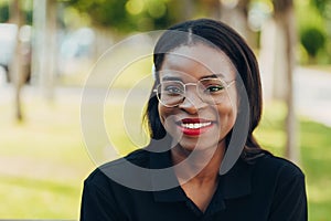 Young cool black skin girl with glasses walking in the street