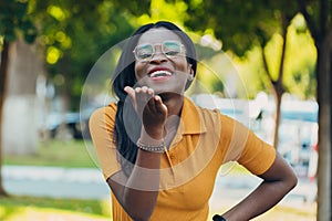 Young cool black skin girl with glasses walking in the street