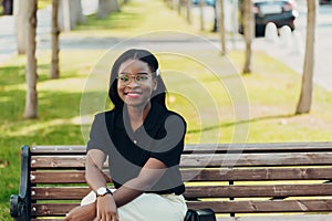 Young cool black skin girl with glasses walking in the street