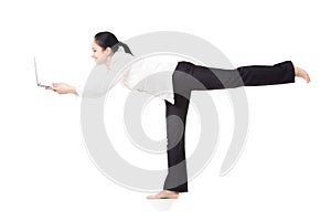 Young corporate worker in yoga pose holding laptop on white back