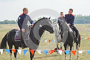 Young Cossacks in traditional costumes on horseback