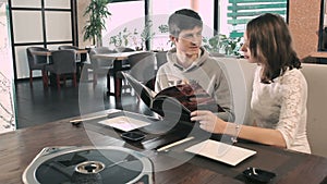 Young couple advised what to order for lunch