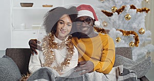 Young couple afro american family boyfriend and girlfriend curly woman and black man wears winter sweaters sitting